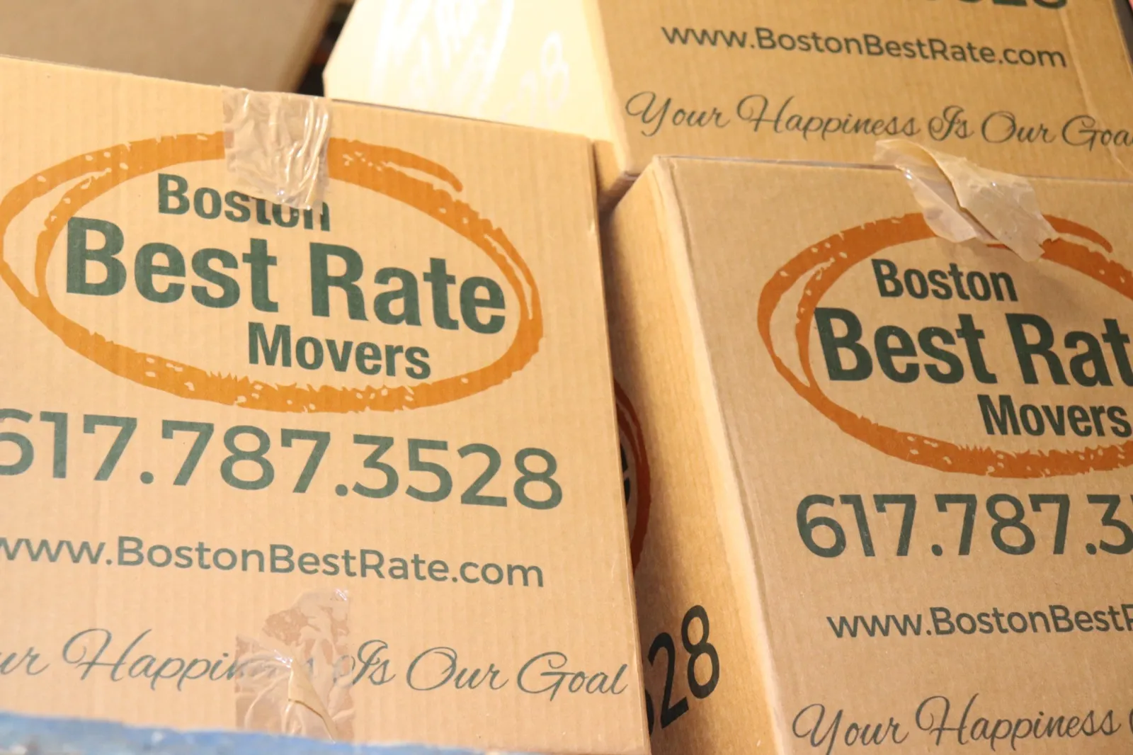 Close-up of Boston Best Rate Movers branded moving boxes with logo