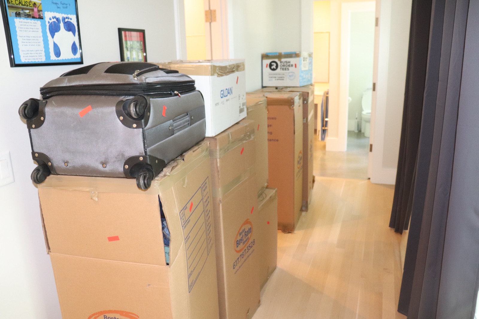Packed boxes lined up in hallway during a residential move
