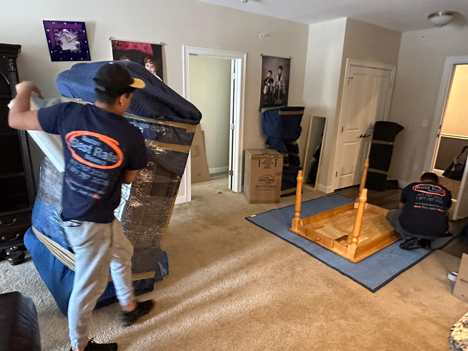 Boston Best Rate Movers crew member carrying furniture during a move